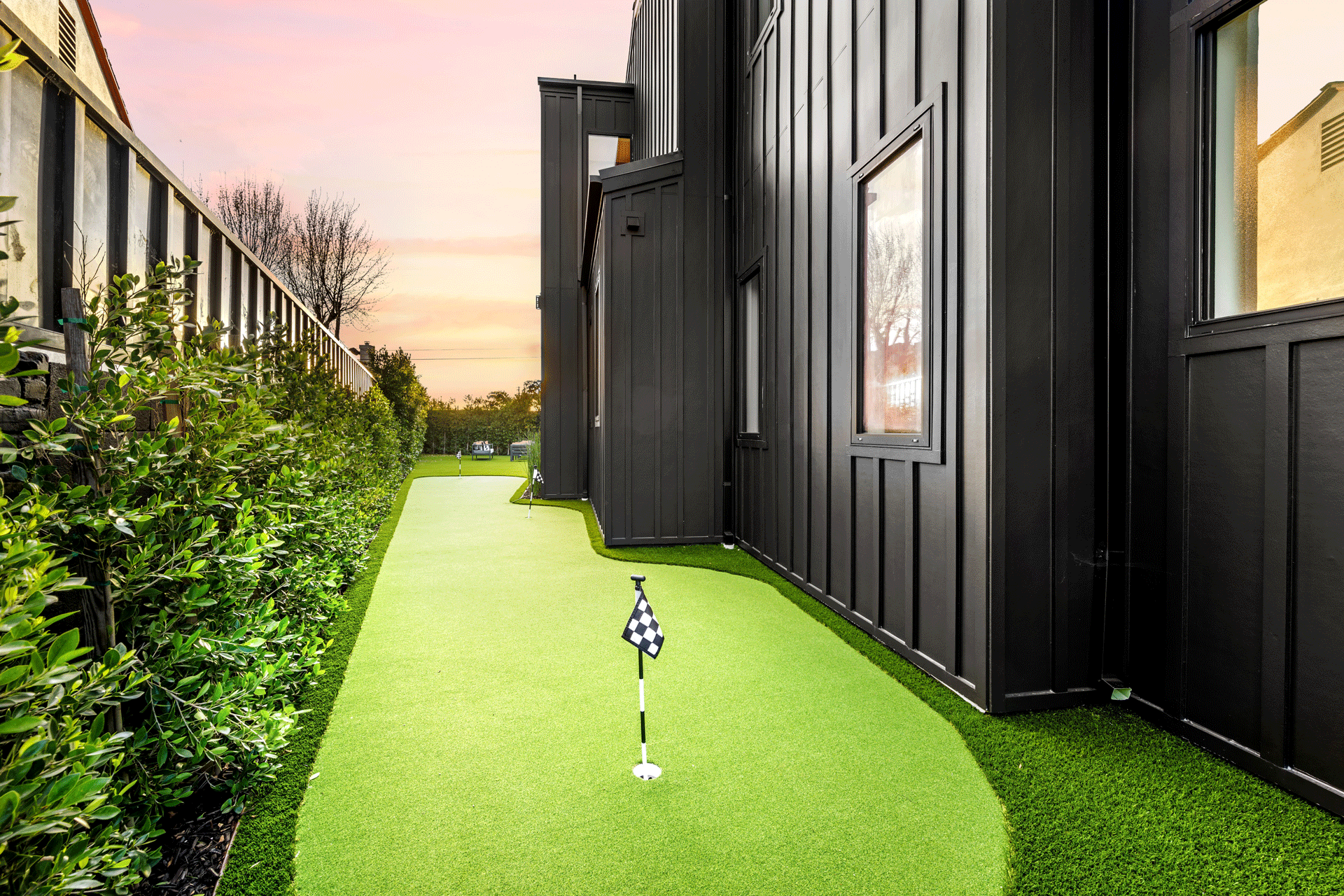 backyard-mini-golf-course-beside-a-modern-black-ho-2025-02-10-06-40-45-utc